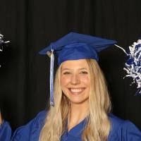 waving pom poms around for a picture at GradFest photo booth